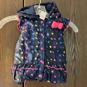 Nannette Kids sleeveless quilted puffer vest. Navy blue with shiny hearts. Size4